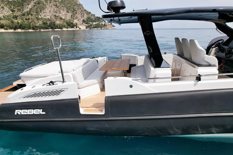 Rebel 47 Yacht Photos Pics 2025 SACS Rebel 47 luxury yacht on clear blue water, featuring sleek design and comfortable seating.