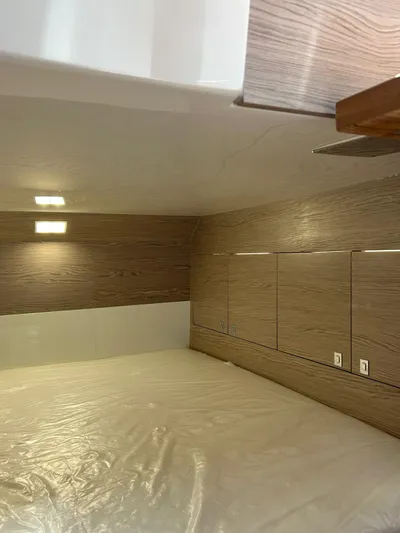 Rebel 47 Yacht Photos Pics Interior cabin of 2025 SACS Rebel 47, featuring modern wood paneling and ambient lighting.