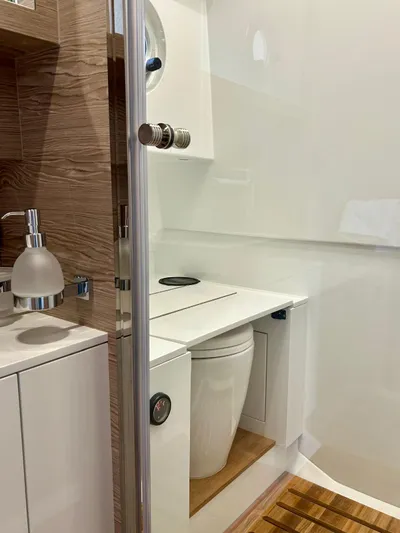 Rebel 47 Yacht Photos Pics Modern bathroom in 2025 SACS Rebel 47 yacht, featuring sleek design and wooden accents.