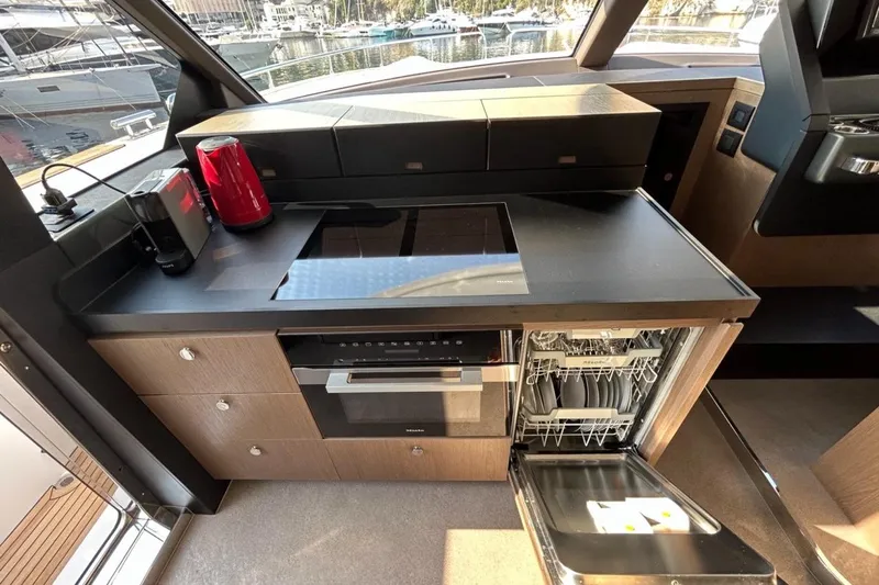  Yacht Photos Pics Modern kitchen in 2022 Azimut Magellano 66 yacht with appliances and open dishwasher.