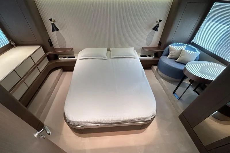  Yacht Photos Pics Luxurious bedroom interior of 2022 Azimut Magellano 66 yacht, featuring modern design and elegant furnishings.