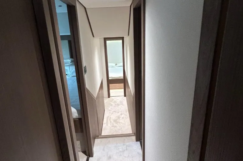  Yacht Photos Pics Interior hallway of 2022 Azimut Magellano 66 yacht, featuring modern design and wood finishes.