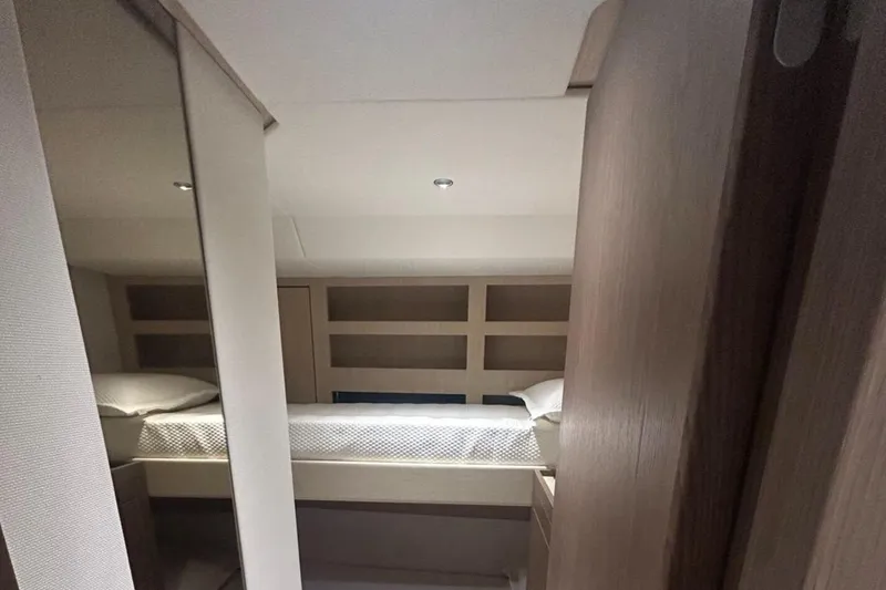  Yacht Photos Pics Interior cabin of 2022 Azimut Magellano 66 yacht, featuring a cozy bed and modern design.