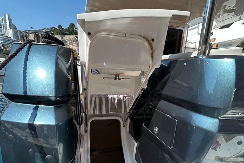  Yacht Photos Pics 2022 Azimut Magellano 66 yacht with open hatch, docked in a marina.