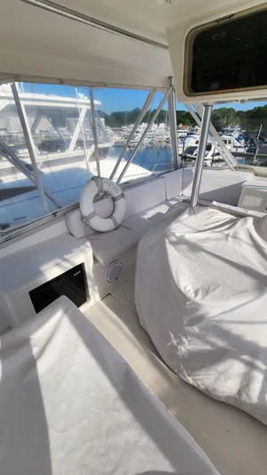 Endurance Yacht Photos Pics 2001 Ocean Yachts 56 Super Sport interior with covered seating and marina view.