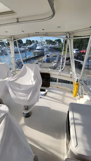 Endurance Yacht Photos Pics 2001 Ocean Yachts 56 Super Sport yacht interior with covered seating and marina view.