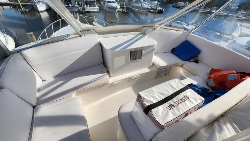 Endurance Yacht Photos Pics 2001 Ocean Yachts 56 Super Sport interior with seating and life jackets, docked at marina.
