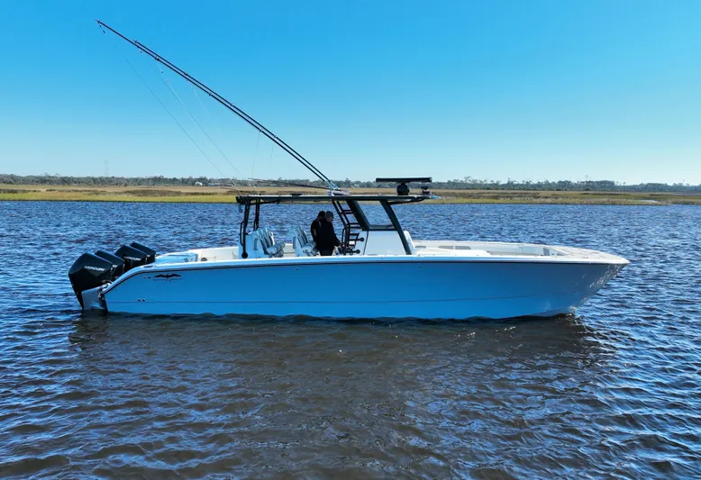  Yacht Photos Pics Invincible 40 Catamaran 2022 on water, side view with clear blue sky.