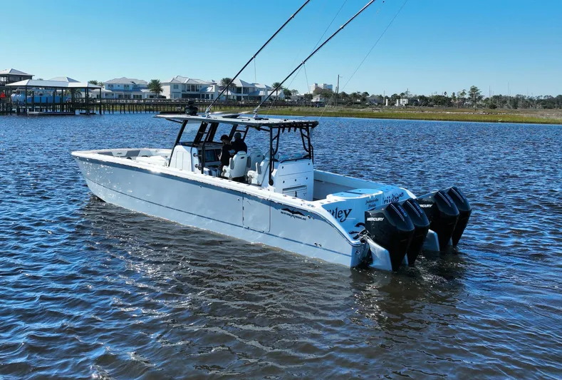  Yacht Photos Pics 2022 Invincible 40 Catamaran on calm water with dual outboard engines.