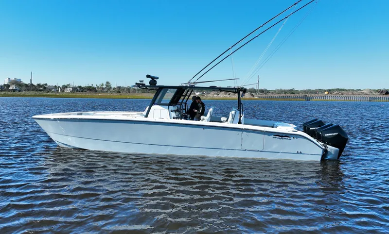  Yacht Photos Pics 2022 Invincible 40 Catamaran on calm water, side view with clear blue sky.