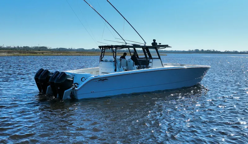  Yacht Photos Pics 2022 Invincible 40 Catamaran on calm water, featuring dual outboard motors.