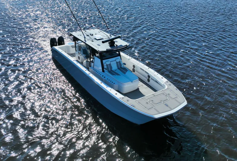  Yacht Photos Pics Invincible 40 Catamaran 2022 on shimmering water, showcasing sleek design and modern features.