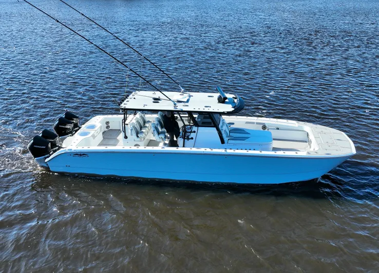  Yacht Photos Pics 2022 Invincible 40 Catamaran on water, showcasing sleek design and powerful engines.