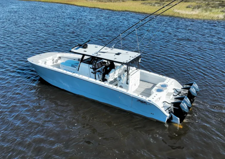  Yacht Photos Pics 2022 Invincible 40 Catamaran on water, featuring dual outboard motors and spacious deck.