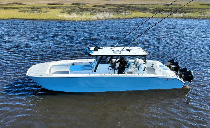  Yacht Photos Pics 2022 Invincible 40 Catamaran on calm water, showcasing sleek design and powerful engines.