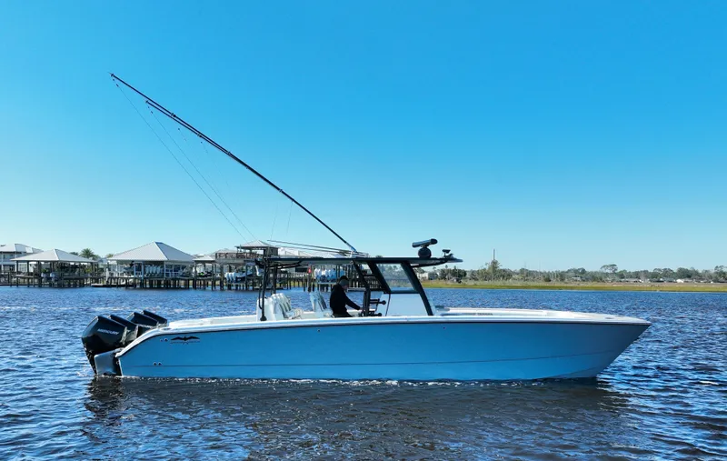  Yacht Photos Pics 2022 Invincible 40 Catamaran on calm water under clear blue sky.