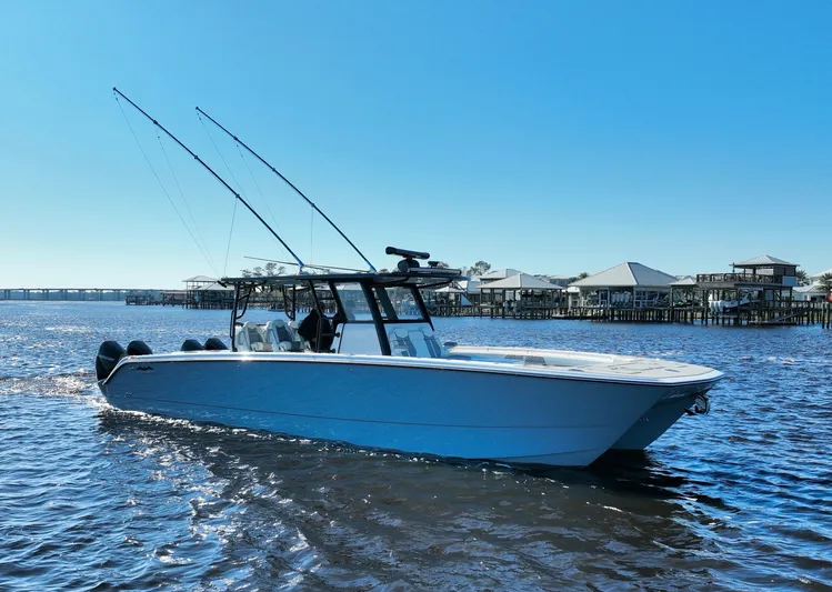  Yacht Photos Pics 2022 Invincible 40 Catamaran on water, clear sky, coastal background.