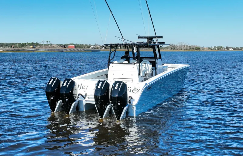  Yacht Photos Pics 2022 Invincible 40 Catamaran with four engines on a calm water body.