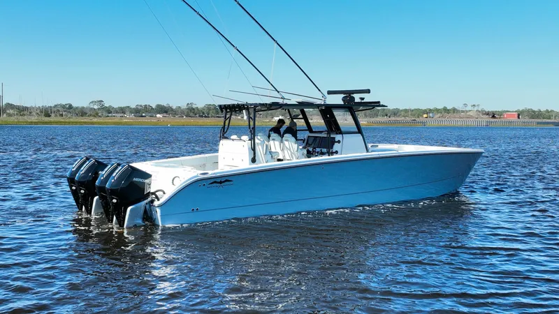  Yacht Photos Pics Invincible 40 Catamaran 2022 on water, featuring dual outboard motors and sleek design.