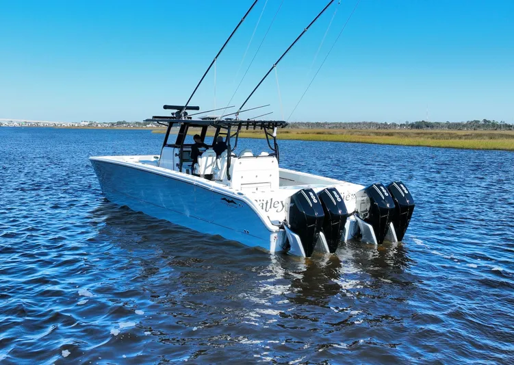  Yacht Photos Pics 2022 Invincible 40 Catamaran on water with four outboard engines, clear blue sky.