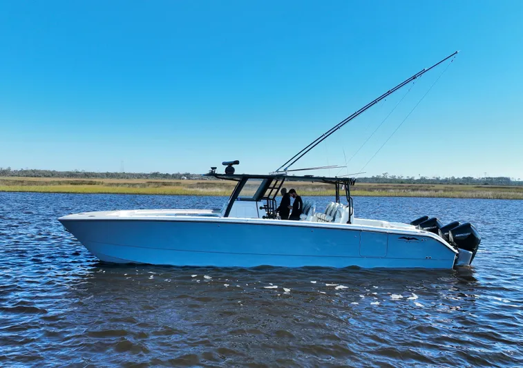  Yacht Photos Pics 2022 Invincible 40 Catamaran on water, clear sky, side view.