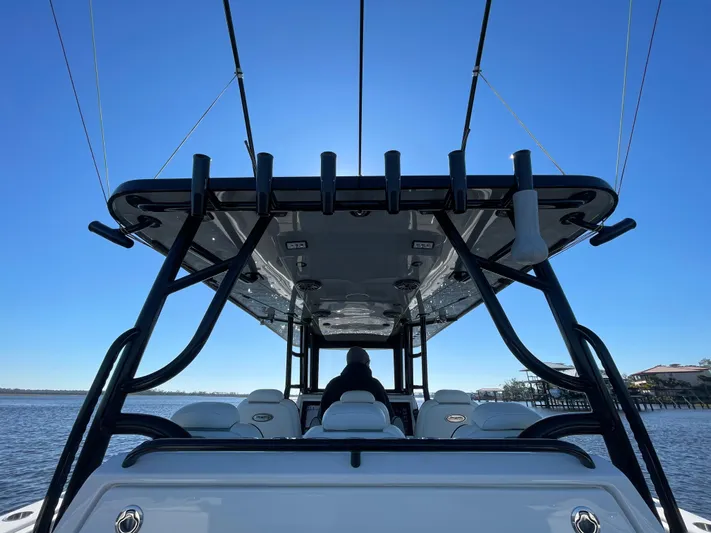  Yacht Photos Pics 2022 Invincible 40 Catamaran, rear view, sleek design, on calm water under clear blue sky.