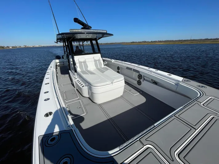  Yacht Photos Pics 2022 Invincible 40 Catamaran on water, showcasing spacious deck and sleek design.