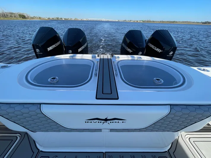  Yacht Photos Pics 2022 Invincible 40 Catamaran with dual Mercury engines on open water.