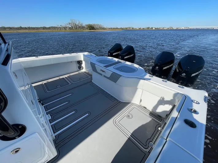  Yacht Photos Pics 2022 Invincible 40 Catamaran with triple Mercury outboards on calm water.