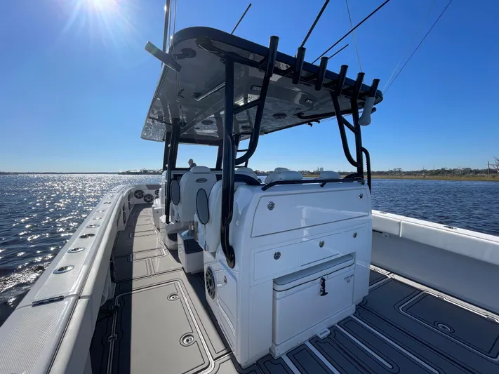  Yacht Photos Pics 2022 Invincible 40 Catamaran on water, showcasing sleek design and spacious deck.