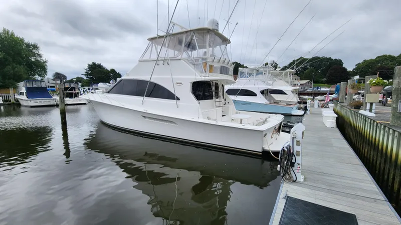 Endurance Yacht Photos Pics 2001 Ocean Yachts 56 Super Sport docked at a marina under cloudy skies.
