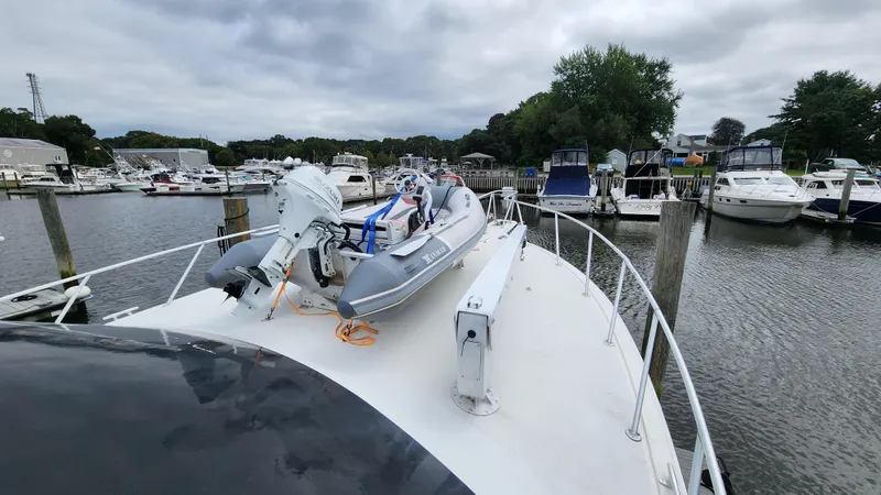 Endurance Yacht Photos Pics 2001 Ocean Yachts 56 Super Sport docked with inflatable boat on deck.