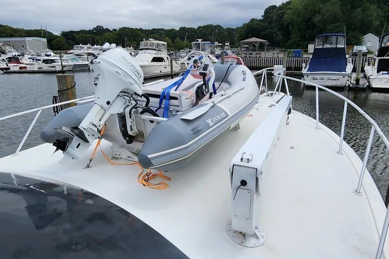Endurance Yacht Photos Pics 2001 Ocean Yachts 56 Super Sport with dinghy on deck, docked at marina.