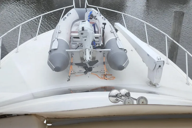 Endurance Yacht Photos Pics 2001 Ocean Yachts 56 Super Sport with inflatable boat on deck, docked on calm water.