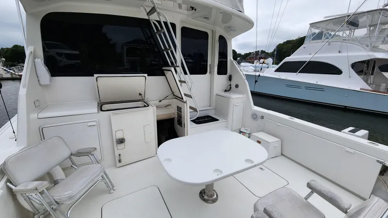 Endurance Yacht Photos Pics 2001 Ocean Yachts 56 Super Sport yacht deck with seating and table, docked at marina.