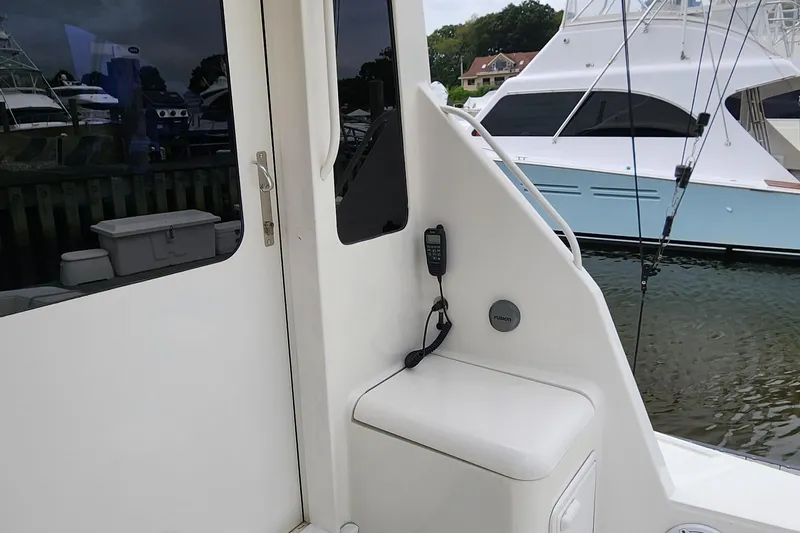 Endurance Yacht Photos Pics 2001 Ocean Yachts 56 Super Sport boat docked, featuring a white exterior and fishing equipment.