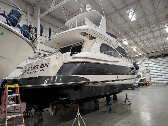 The Last Run Yacht Photos Pics 2003 Cruisers Yachts 5000 Sport Sedan in a spacious indoor marina.