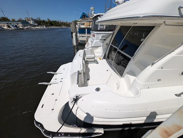 The Last Run Yacht Photos Pics 2003 Cruisers Yachts 5000 Sport Sedan docked at marina, rear view.