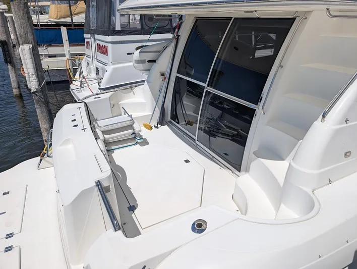 The Last Run Yacht Photos Pics 2003 Cruisers Yachts 5000 Sport Sedan docked, featuring spacious deck and sleek design.