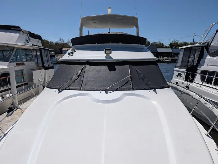 The Last Run Yacht Photos Pics 2003 Cruisers Yachts 5000 Sport Sedan docked, featuring sleek design and spacious deck.