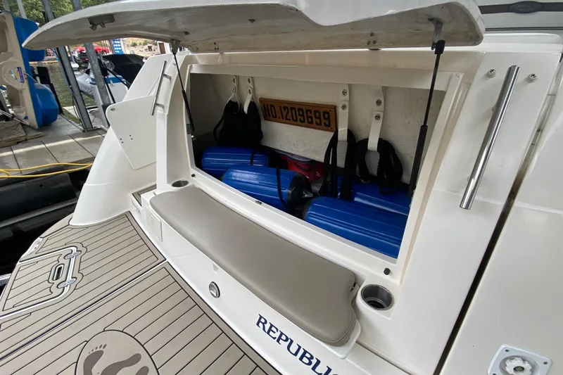  Yacht Photos Pics 2008 Rinker 350 Express Cruiser storage compartment with blue fenders and accessories.