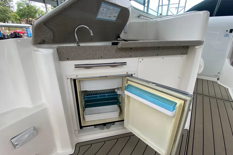  Yacht Photos Pics 2008 Rinker 350 Express Cruiser kitchenette with open mini fridge and sink.