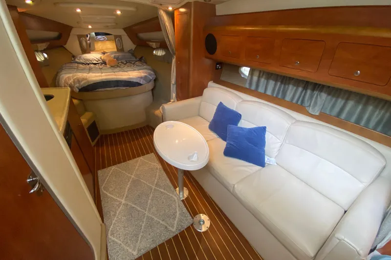  Yacht Photos Pics 2008 Rinker 350 Express Cruiser interior with cozy bed, sofa, and elegant wood finish.