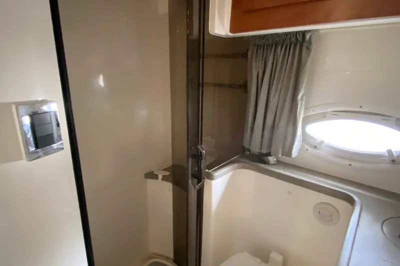  Yacht Photos Pics 2008 Rinker 350 Express Cruiser bathroom with shower, curtain, and porthole window.