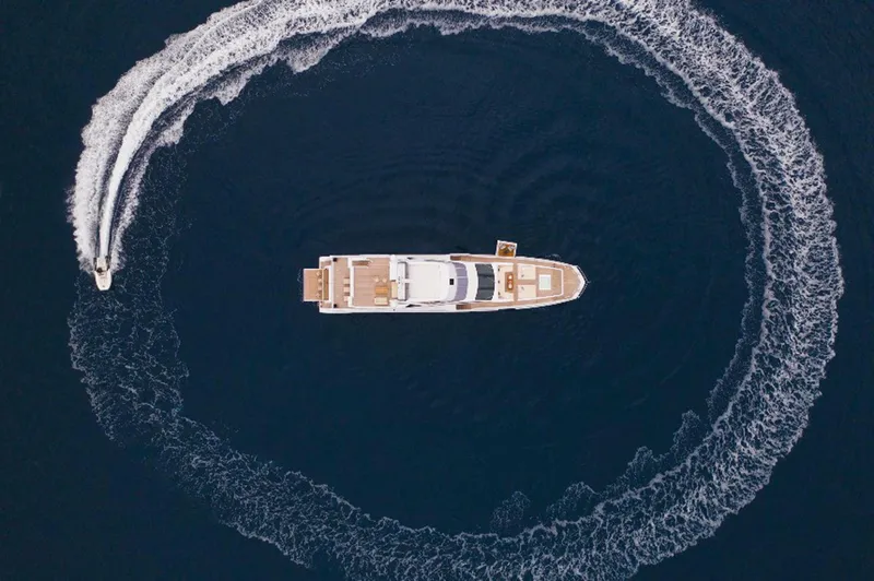 Sama Yacht Photos Pics Aerial view of 2017 Azimut Grande 35 Metri yacht with speedboat circling.