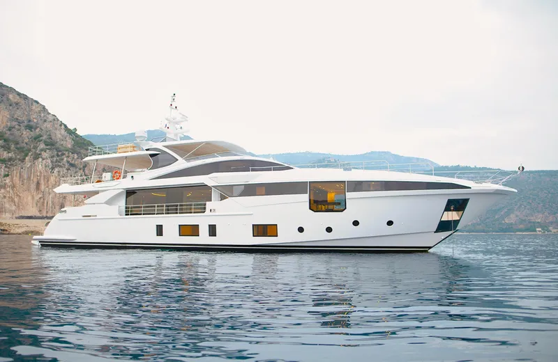 Sama Yacht Photos Pics Luxury Azimut Grande 35 Metri yacht, 2017 model, cruising near rocky coastline.