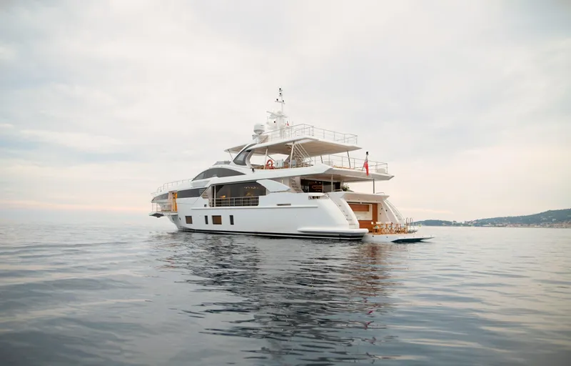 Sama Yacht Photos Pics Luxury yacht Azimut Grande 35 Metri 2017 on calm sea under cloudy sky.