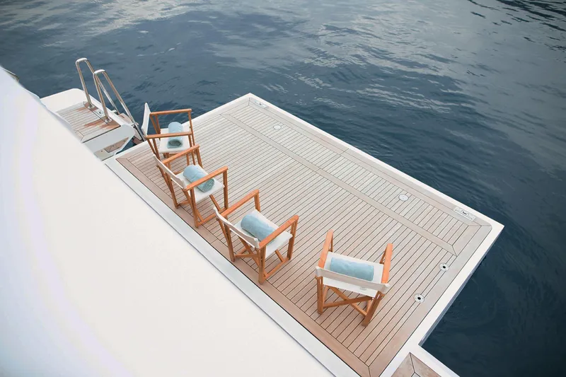 Sama Yacht Photos Pics Luxury yacht deck with chairs, Azimut Grande 35 Metri, 2017 model, overlooking calm sea.