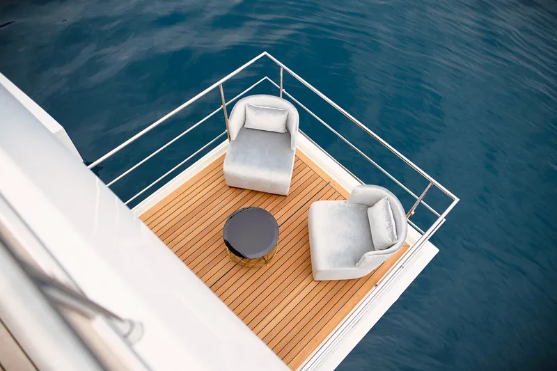 Sama Yacht Photos Pics Luxury deck on 2017 Azimut Grande 35 Metri yacht with chairs and table, overlooking the sea.