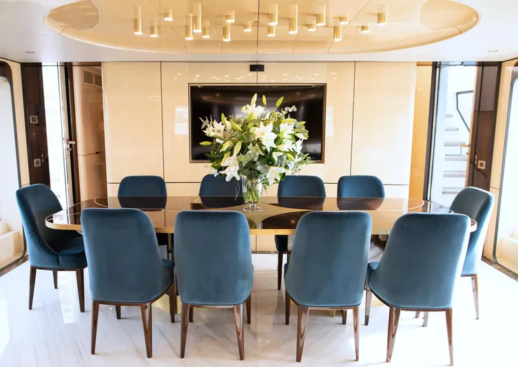 Sama Yacht Photos Pics Luxurious dining area on 2017 Azimut Grande 35 Metri yacht with elegant blue chairs.
